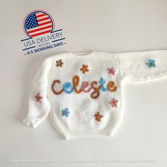 🌟 A Timeless Treasure: Hand-Embroidered Personalized Baby Sweater 🌟 Introducing our hand-embroidered personalized baby sweater, a timeless treasure that will warm your heart as much as it warms your little one. Made of the softest yarn and delicately personalized with your child's name, this sweater is more than just clothing--it's a symbol of love and a keepsake to be cherished for life. 🧶 Craftsmanship at Its Finest: Each sweater is meticulously hand-embroidered by our skilled artisans with Winter Sweater With Letter Embroidery, White Knitted Cotton Sweatshirt, Cream Letter Print Sweater For Winter, Cream Winter Sweater With Letter Print, Winter Cream Sweater With Letter Print, Playful Letter Print Sweater For Fall, Playful White Knitted Top, Cute Letter Embroidery Sweatshirt For Winter, White Letter Embroidery Sweater For Winter