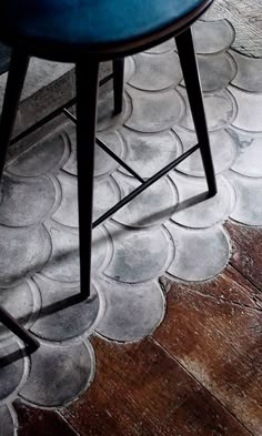 a blue chair sitting on top of a wooden floor