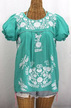 "The \"La Mariposa Corta\" Mexican Blouse by Siren: * Ornate hand embroidery and traditional puff sleeves, available here in MINT GREEN with WHITE embroidery. * Light, gauzy and semi-sheer 100% cotton throughout; wear it billowy and flowing in the traditional bohemian style. * Dyed, distressed and embroidered entirely by hand for an authentic, retro-vintage and hippie casual vibe. * Our ornate butterfly floral embroidery patterns are a faithful tribute to the original Mexican style hippie blouse Mexican Peasant Blouse, Hippie Blouse, Pattern Outfits, Mexican Blouse, Minty Fresh, Floral Embroidery Patterns, Traditional Mexican, Mexican Dresses, Muslin Fabric