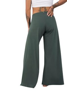 Our wide leg olive green pants by Ekoluxe. A perfect summer style, work from home outfit, beach date outfit or best everyday fashion ideas. Flowy pants with breezy side slits, drawstring wrap & tie style, accented with gold branded charms. Create a boho look, cozy clothes aesthetic or baggy pants outfit style with our wide leg trousers. We focus on ethical chic lounge wear for women using sustainable materials, handcrafted with purpose & versatility. Learn more at Ekoluxe.co #alwaysdoboth Cozy Clothes Aesthetic, Green Flowy Pants, Beach Date Outfit, Split Leg Pants, Baggy Pants Outfit, Flowy Wide Leg Pants, Cozy Clothing, Work From Home Outfit, Cozy Clothes