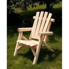 a wooden chair sitting in the grass