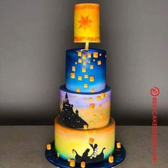 a three tiered cake decorated with cartoon characters