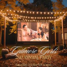 an outdoor movie screen with lights strung over it and the words, ultimate girls and annual party