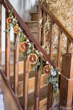 some oranges are hanging on the banister