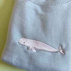 Belgua whale embroidered Hoodie. Soft Cotton drop shoulder style with stylish fit. Designed and Embroidered in the UK. Unisex Fit. We donate money to animal charities. JUMPER INFO Twin needle stitching. We use sustainable fabric and the jumper is fair trade certified. Sweatshop free and WRAP certified. Shipped in recyclable and biodegradable packaging.   SIZING UK (unisex fit) X-Small approx Size 6-8 Small approx Size 8-10 Medium  approx Size 12-14 Large  approx Size 16 X Large  approx Size 18-2 Ocean Embroidery, Beluga Whale, Embroidered Clothes, Embroidered Sweatshirt, Embroidered Hoodie, Cozy Sweatshirts, Embroidered Sweatshirts, Sustainable Fabrics, Whales