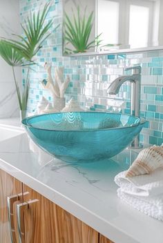 a glass bowl sink sitting on top of a counter