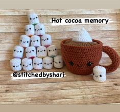 crocheted coffee cup with marshmallows in front of it