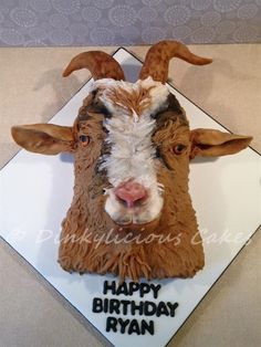 a birthday cake with a goat's head on it