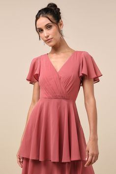 We know that some of your favorite memories will be made while wearing the Lulus Sincerely Exquisite Rusty Rose Short Sleeve Tiered Maxi Dress! This timeless dress has an airy woven chiffon composition that shapes a lightly gathered bodice with a surplice neckline and V-back, framed by fluttery short sleeves. The high, fitted waist tops a flowy, tiered A-line skirt that falls to an elegant maxi hem. Hidden back zipper/clasp. Fit: This garment fits true to size. Length: Floor length. Size medium Elegant Pink Flowy Chiffon Dress, Pink Bridesmaid Dress With Flowy Skirt, Pink A-line Chiffon Bridesmaid Dress, Feminine Flowy Chiffon Mini Dress, Flowy Chiffon Mini Dress In Feminine Style, Pink Chiffon V-neck Mini Dress, Chic Pink A-line Chiffon Dress, Chiffon V-neck Mini Dress For Garden Party, Flowy Feminine Chiffon Bridesmaid Dress