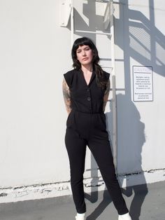 This pantsuit really is magic.✨ It's a one and done outfit that looks flattering without compromising one bit on comfort! Made in our super soft stretch cotton jersey, it features three buttons down the torso so it's easy to slip on, an elastic waistline, side pockets and slightly tapered legs. This jumpsuit is the comfiest way to look cool. Fitted Cotton Pantsuit For Work, Casual Fitted Pantsuit For Work, Casual Stretch Pantsuit For Work, Fitted Casual Pantsuit For Business Casual, Fitted Cotton Jumpsuits And Rompers With Buttons, One And Done, Consignment Boutique, Suit Black, Black Media