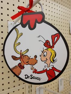 a christmas ornament hanging from the side of a wall with a cartoon character on it