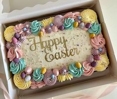 a birthday cake in a box with the words happy easter written on it