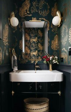 a white sink sitting under a mirror next to a wall mounted faucet in a bathroom