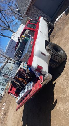 a red and white truck parked next to a building