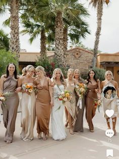 a group of women standing next to each other in front of palm trees and buildings