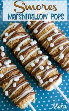 marshmallow pops with white chocolate drizzle on top and blue polka dot background