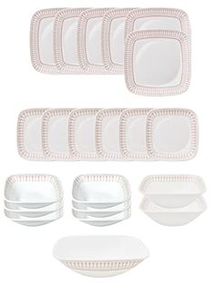 a set of white dishes and plates with pink trimmings on the edges,