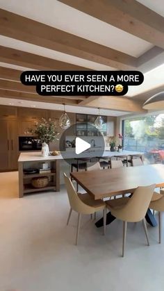 a kitchen with a large wooden table and chairs next to an open window that says have you ever seen a more perfect kitchen?