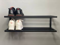 two pairs of shoes are sitting on a shelf