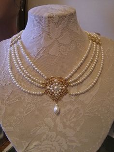 LIMITED ָָָָָָָָָ Beautiful Bridal choker features four strands of small cream Ivory pearls with a golden flower filigree set with Ivory pearls and a Swarovski drop pearl is dangle below.Between the lines of the pearls I connected the separate golden findings set with rhinestone. Its Elegant Cream Pearl Necklace For Wedding, Elegant Cream Jewelry For Wedding, Delicate Pearl Drop Choker For Wedding, Classic Pearl Choker For Wedding, Pearl White Round Beads Wedding Choker, Classic Multi-strand Pearl Necklace For Wedding, Pearl White Round Beads Choker For Wedding, Delicate Pearl Choker For Wedding, Pearl White Wedding Choker With Round Beads