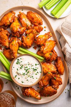 chicken wings and celery on a plate with ranch dressing