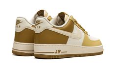 The Nike Air Force 1 Low "Bronzine" is a colorway of the retro basketball and lifestyle sneaker with light and dark gold accents.  A can’t-miss look for the Air Force 1, the “Bronzine” features a white leather base and Bronzine and Saturn Gold leather panels.  A Coconut Milk leather Swoosh is seen on both sides, while “Nike Air” detailing is embroidered on the heel and an “Air Force 1” logo is printed on the tongue tag.  The Sail rubber midsole gives the shoe a vintage look. Retro Basketball, Light Sneakers, 1 Logo, Nike Air Force 1 Low, Stadium Goods, Air Force 1 Low, Dark Gold, Gold Leather, Nike Air Force 1