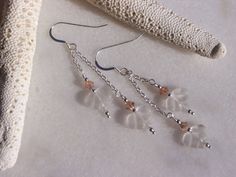 Double chain earrings each hung with a lovely hand carved frosted Quartz Crystal leaf with Sterling Silver and peach Swarovski Crystals. These earring are 2.63 inches in total length. They will be shipped to you gift wrapped ready for giving or just to make your day extra special. If you'd like me to include a personal message from you, please leave me a note at checkout, I'd be happy to include a handwritten note with the gift. Rock Crystal Jewelry, Earring Inspo, Pink Crystal Earrings, Long Silver Earrings, Ivory Earrings, Swarovski Crystal Jewelry, Pink Swarovski, Diy Wire Jewelry, Leaf Jewelry