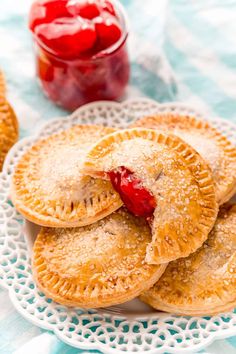 three small pies on a plate with jelly in the background