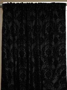 a black curtain hanging on the side of a wall