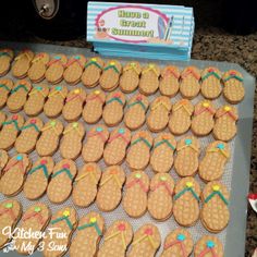 a table topped with lots of cookies and flip flops on top of each other