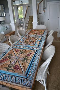 a dining room table painted with an intricate design