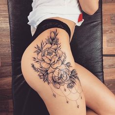 a woman's thigh with flowers on it