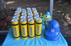 there are many yellow cylinders on the blue tablecloth with toy figures next to them