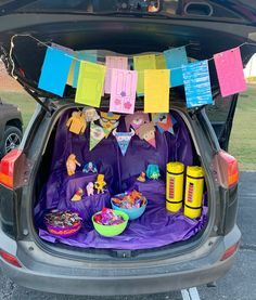 the trunk of a car is filled with decorations