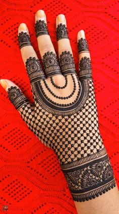 a woman's hand with henna tattoos on it