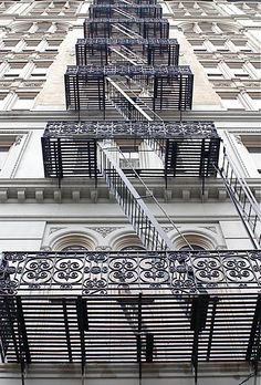 an apartment building with many balconies and wrought iron railings on the front