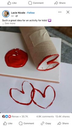 a roll of toilet paper sitting on top of a piece of paper with red ink