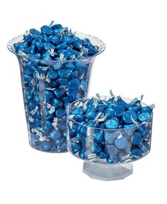 two clear vases filled with blue candy