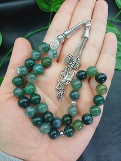 This listing is for 1 pc 33 beaded tasbih. Product Details: 💚 Bead size: 10 mm  💚 Bead count: 33 beads 💚 Bead cut: Round  💚 Gemstone: Moss Agate  💚 Spacers: Silver colored metals 💚 Gemstone Quality: AAA Grade (High Quality) 💚 Cord: Parachute thread ✔️ 33 beaded Islamic Misbaha ✔️ 10 mm big size Moss Agate gemstone Rosary  ✔️ Natural Green Color Tasbeeh  ✔️ Luxury Natural Aqiq Stone Tesbih  ✔️ High grade large Moss Aqeeq Stone beads ✔️ Silver colored metal aparats  ✔️ Strong Parachute thre Prayer Beads, Agate Gemstone, Moss Agate, Big Size, Rosary, Stone Beads, Bead Charms, Silver Color, Mousse