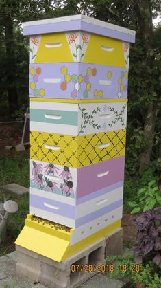 a beehive made out of cardboard and painted with flowers