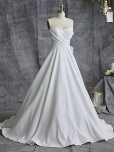 a white wedding dress on a mannequin