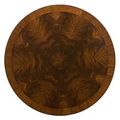 a round wooden table with an intricate design on the top and bottom part, inlaid with leaves