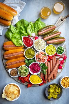 a platter filled with lots of different types of vegetables and dips on top of it