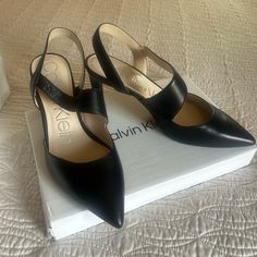 Calvin Klein Black Pumps With Strap Size 7 Black Slingback Pumps With Branded Insole For Work, Calvin Klein Chic Ankle Strap Heels, Chic Calvin Klein Ankle Strap Heels, Sleek Black Slingback Pumps With 4-inch Heel, Calvin Klein Leather Heels With Heel Strap, Elegant Calvin Klein Heels With Heel Strap, Sleek Calvin Klein Heels For Party, Elegant Calvin Klein Heels With Strap, Chic Calvin Klein Heels With Sculpted Heel