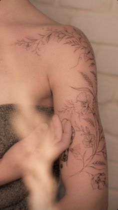 a man with a flower tattoo on his arm