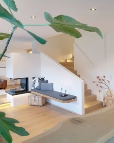 a living room filled with furniture next to a stair case