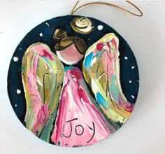 a ceramic ornament with an angel painted on it