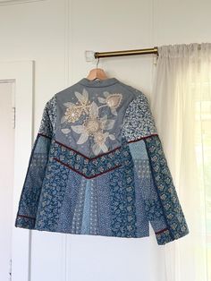 a 1980s handmade reversible, quilt jacket. one side is a corn flower blue print with lined pockets and other side has multiple patterns with crochet doily flowers on back. features tiny mirrors, hand made leaves, frog buttons and lined pockets. in amazing vintage condition eith no rips tears or stains. chest 37' length 25' sleeve 24' shoulder 4' Doily Flowers, Corn Flower Blue, Frog Buttons, Quilted Sweater, Corn Flower, Quilt Jacket, Flower Blue, Crochet Doily, Reversible Quilt