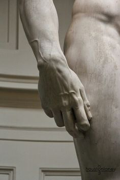 a close up of a statue of a person holding his hand