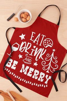 an apron with the words eat, drink and be merry on it next to some utensils